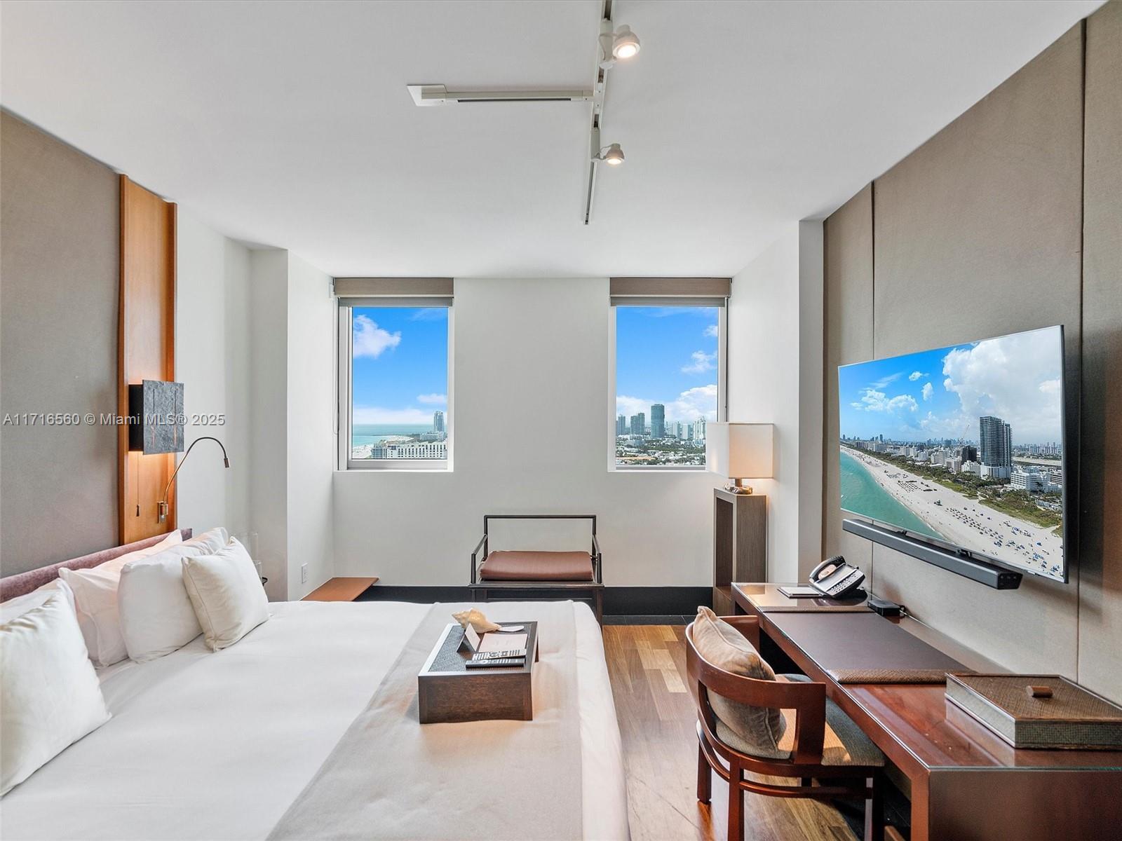 101 20th Street, Unit 3302 Miami Beach, FL 33139 - Photo 24 of 48 a bedroom with furniture and a flat screen tv