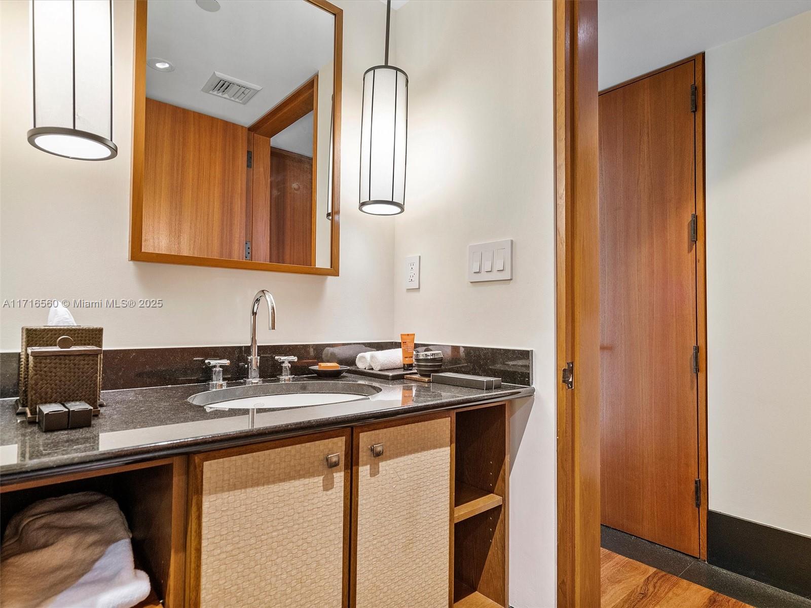 101 20th Street, Unit 3302 Miami Beach, FL 33139 - Photo 39 of 48 a bathroom with a sink and a mirror