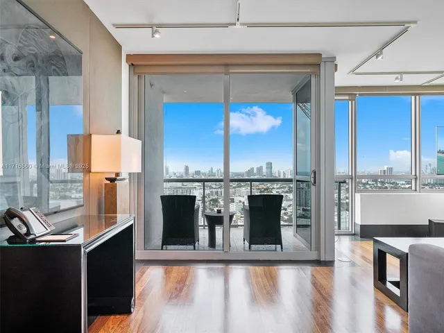 a view of a living room with a large window