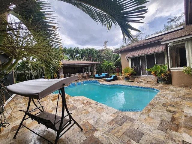 a view of a swimming pool with an outdoor seating