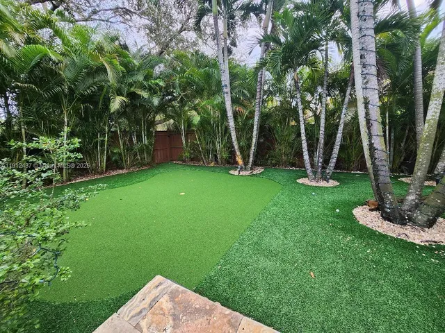 a view of a dining room with furniture wooden floor and chandelier