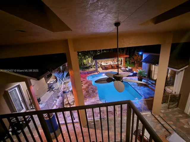 a kitchen with stainless steel appliances granite countertop wooden cabinets a stove a sink and a microwave