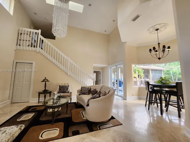 a spacious bathroom with a tub mirror and window