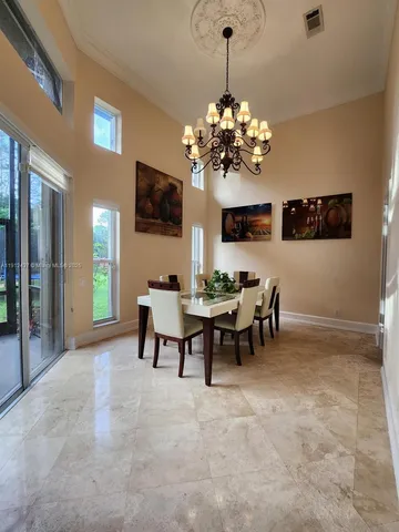 a spacious bathroom with a granite countertop sink a toilet a mirror and shower