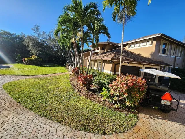 a view of a house with pool and chairs