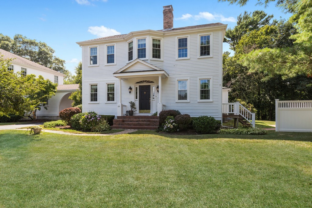 1193 Main Street, Unit D1 Hingham, MA 02043 - Photo 1 of 34 a front view of a house with a yard and garage