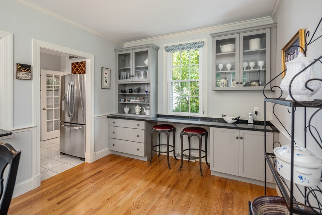 1193 Main Street, Unit D1 Hingham, MA 02043 - Photo 13 of 34 a kitchen with stainless steel appliances granite countertop a refrigerator and a stove top oven