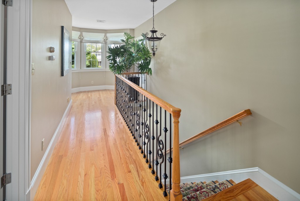 1193 Main Street, Unit D1 Hingham, MA 02043 - Photo 14 of 34 a view of a hallway with wooden floor and stairs