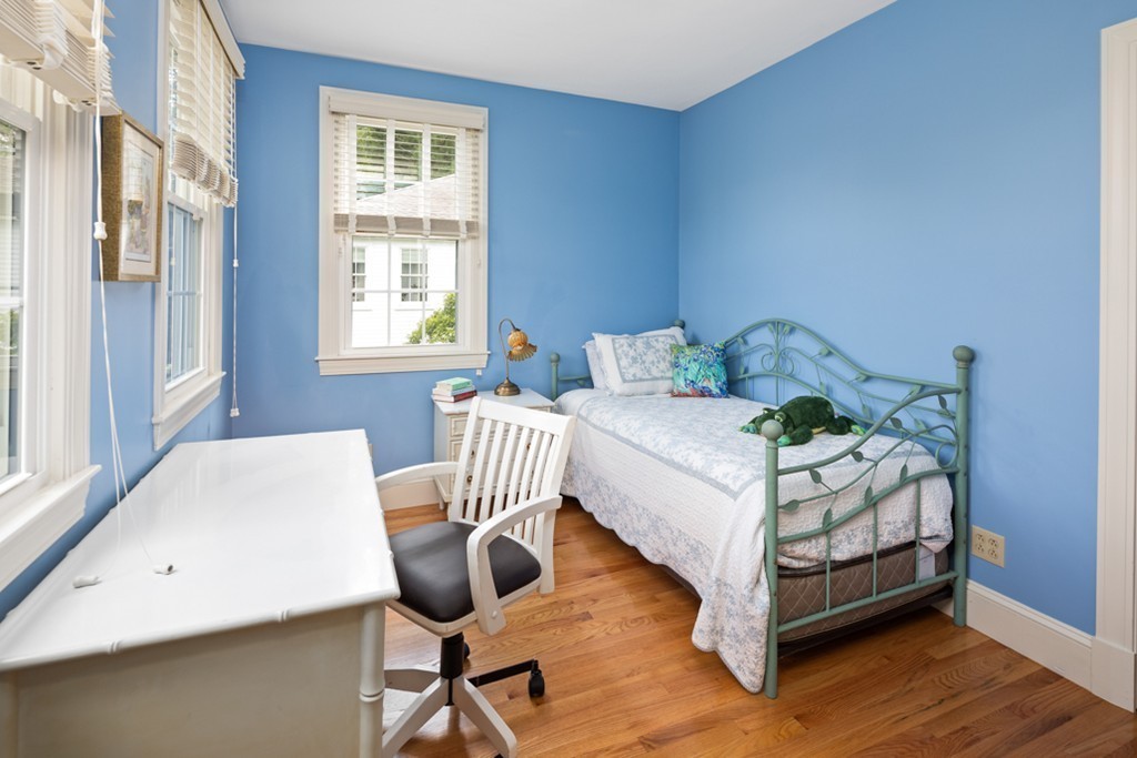 1193 Main Street, Unit D1 Hingham, MA 02043 - Photo 18 of 34 a bedroom with a bed a table and windows