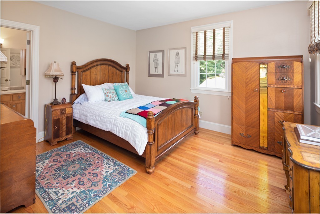 1193 Main Street, Unit D1 Hingham, MA 02043 - Photo 20 of 34 a bedroom with a bed lamp and a large window