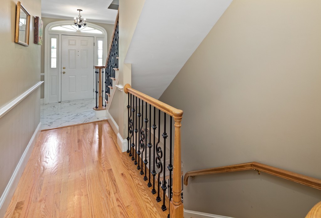 1193 Main Street, Unit D1 Hingham, MA 02043 - Photo 22 of 34 a view of a hallway with wooden floor and staircase