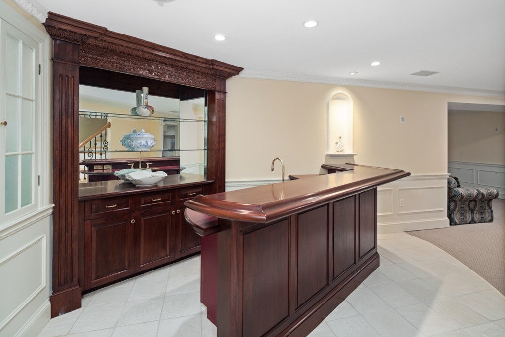 1193 Main Street, Unit D1 Hingham, MA 02043 - Photo 24 of 34 a kitchen with a sink and wooden cabinets