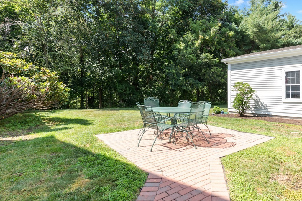 1193 Main Street, Unit D1 Hingham, MA 02043 - Photo 34 of 34 a view of a chairs and table in the patio