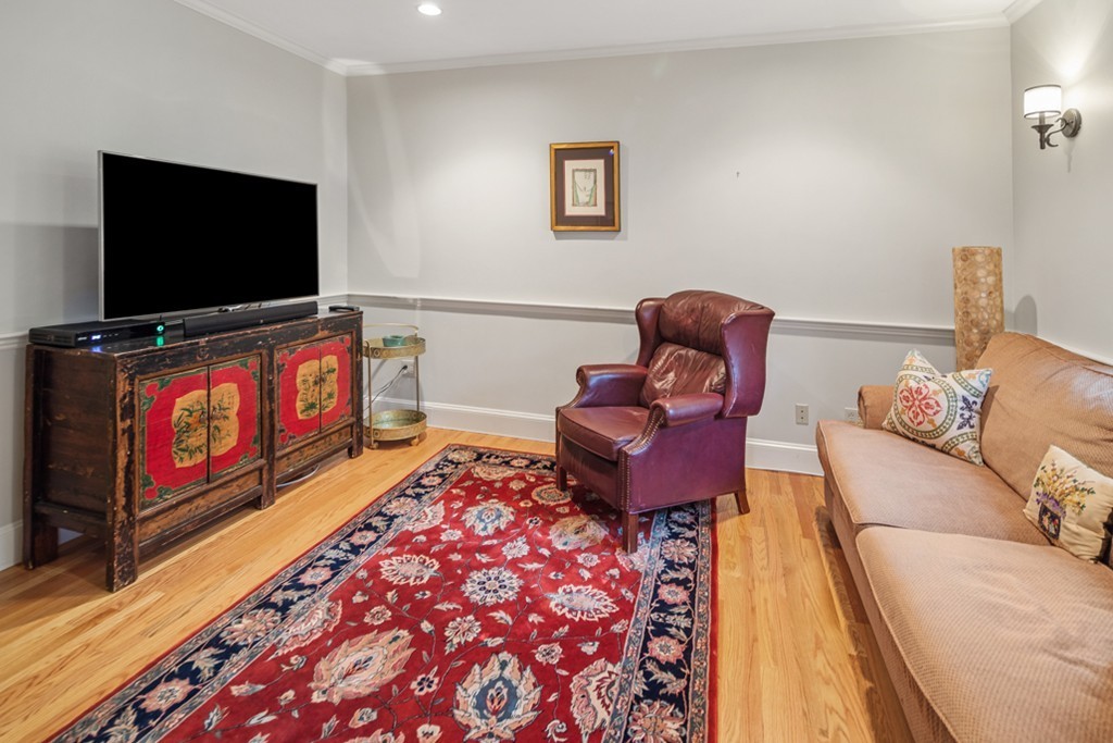 1193 Main Street, Unit D1 Hingham, MA 02043 - Photo 4 of 34 a living room with furniture and a flat screen tv