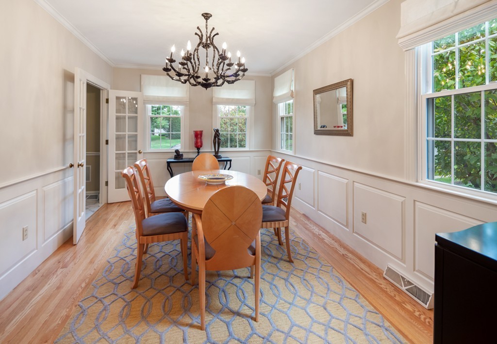 1193 Main Street, Unit D1 Hingham, MA 02043 - Photo 7 of 34 a view of a dining room with furniture a chandelier and wooden floor