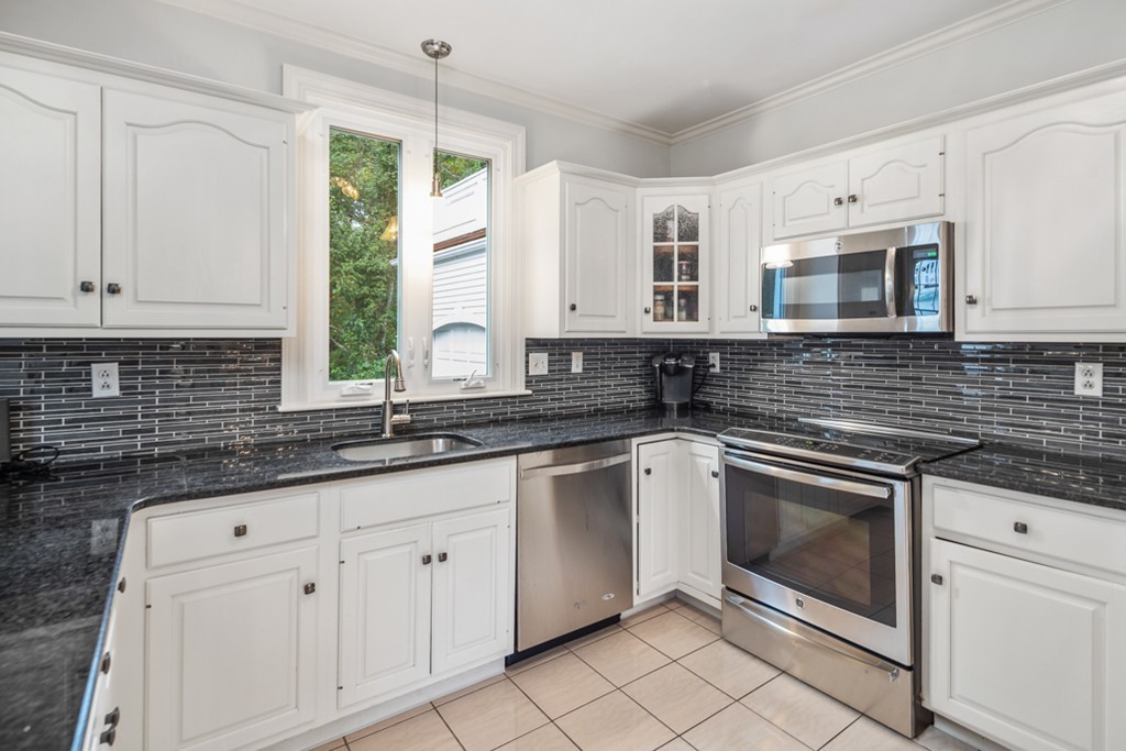 1193 Main Street, Unit D1 Hingham, MA 02043 - Photo 10 of 34 a kitchen with granite countertop white cabinets white appliances with a sink and dishwasher