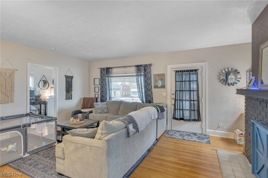 5880 State Road Cleveland, OH 44134 - Photo 2 of 21 Living room featuring light hardwood / wood-style flooring and a fireplace