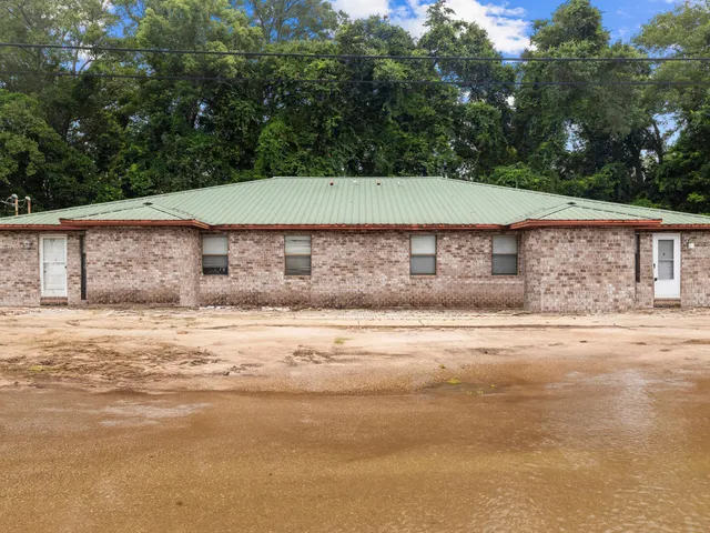 a house that has a swimming pool in front of it