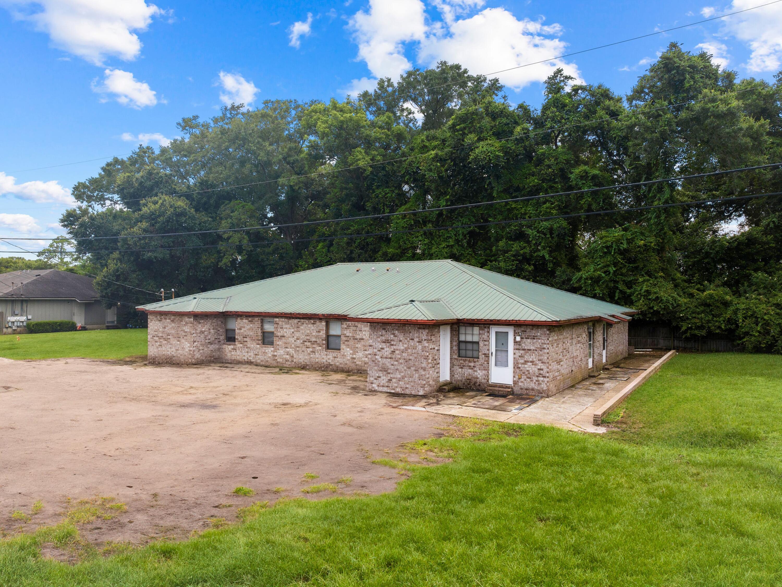 130 East 9 Mile Road, Unit 58 Pensacola, FL 32534 - Photo 2 of 50 a view of a house with a yard and sitting area