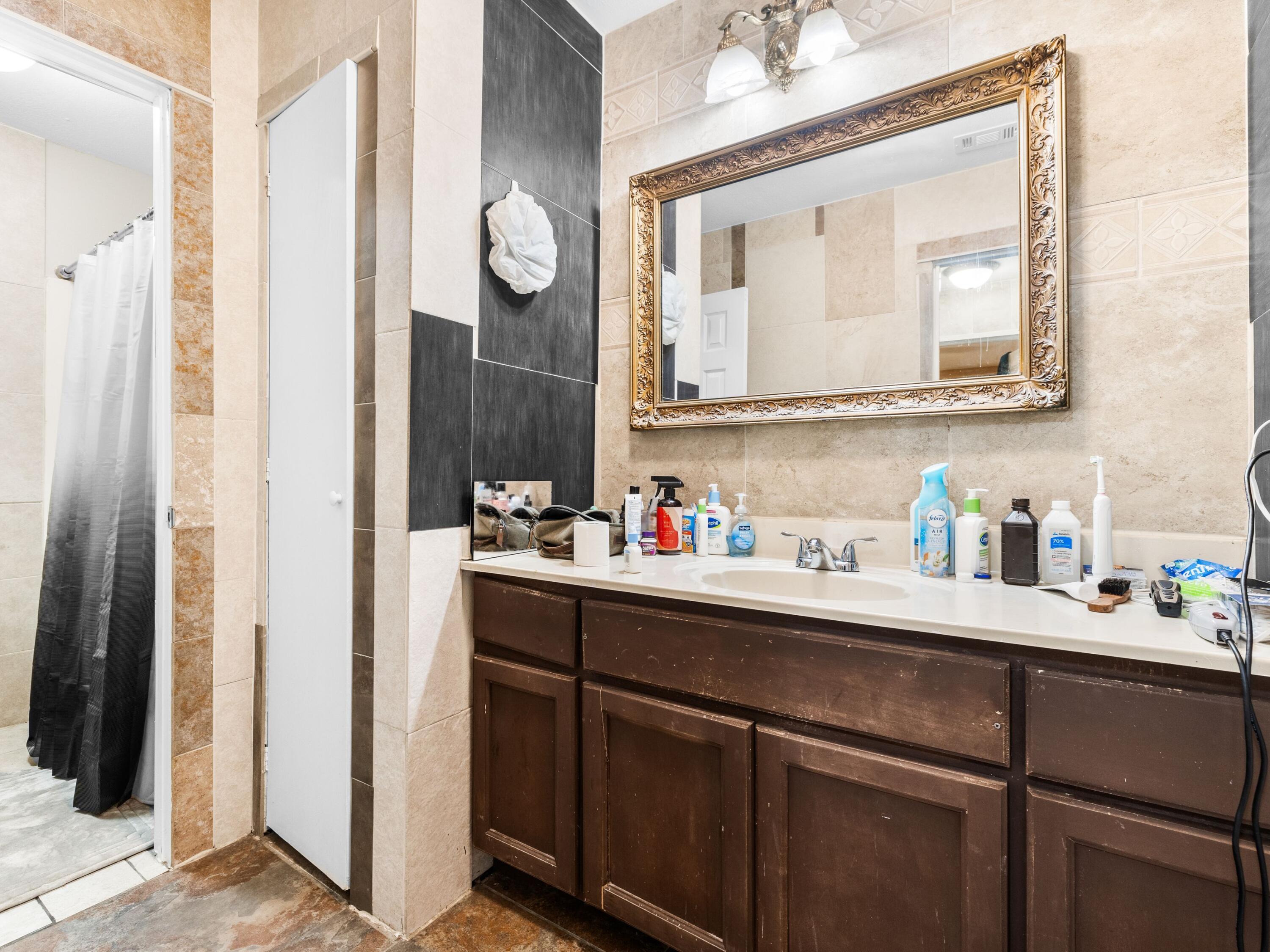 130 East 9 Mile Road, Unit 58 Pensacola, FL 32534 - Photo 25 of 50 a bathroom with a sink vanity and a mirror