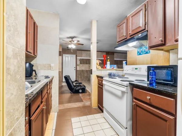 a kitchen with stainless steel appliances granite countertop a stove and a sink