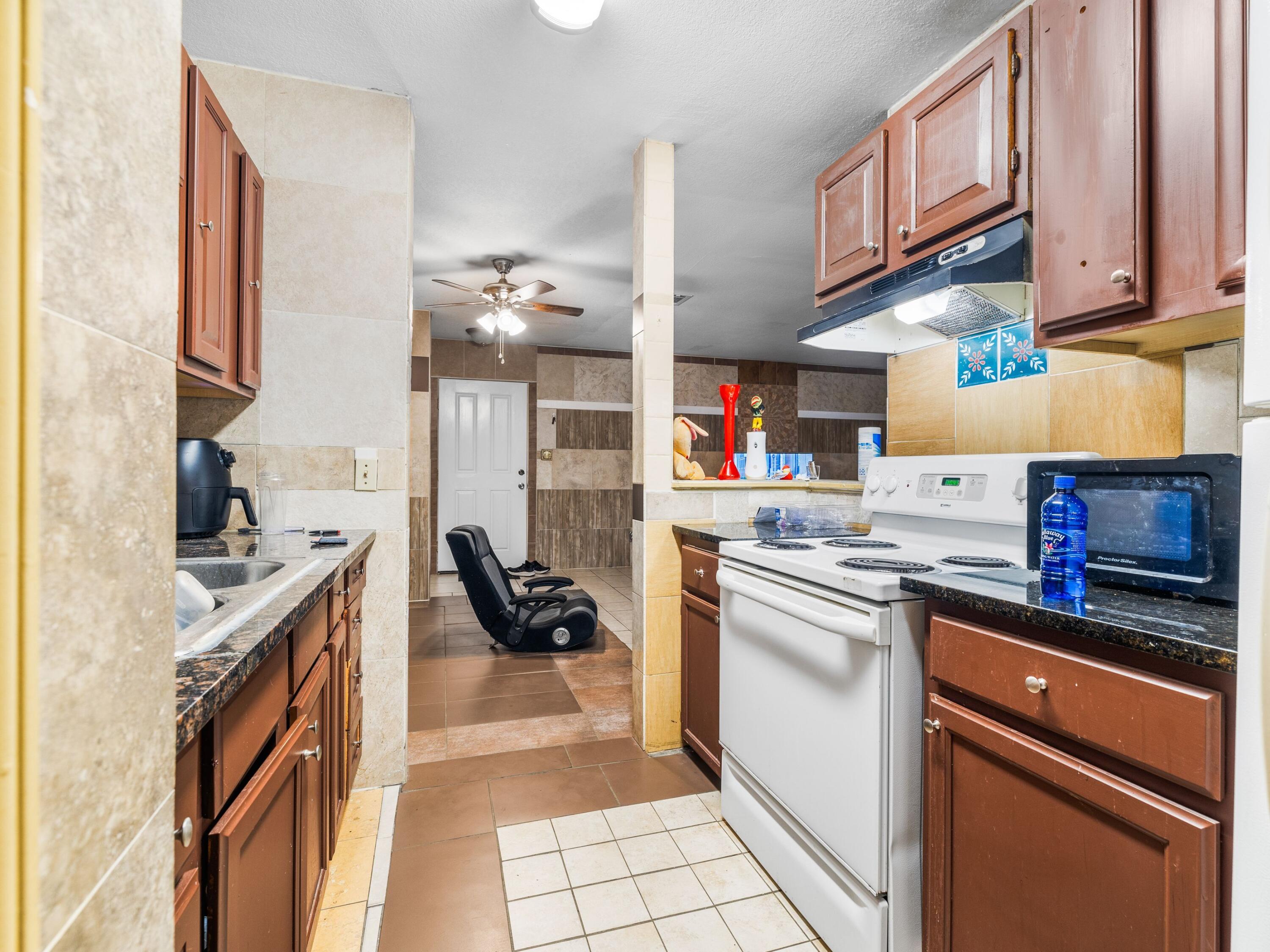 130 East 9 Mile Road, Unit 58 Pensacola, FL 32534 - Photo 30 of 50 a kitchen with stainless steel appliances granite countertop a stove and a sink
