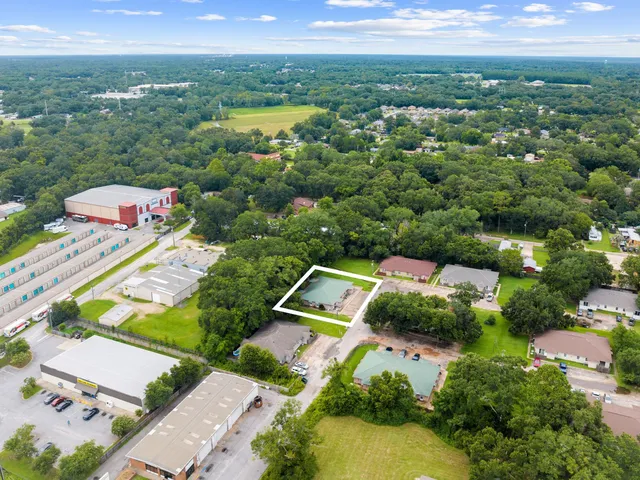 an aerial view of residential houses with outdoor space and river