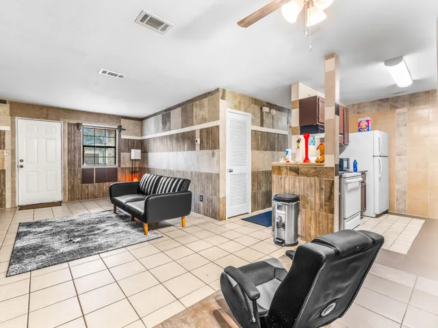 a bedroom with furniture and a book shelf