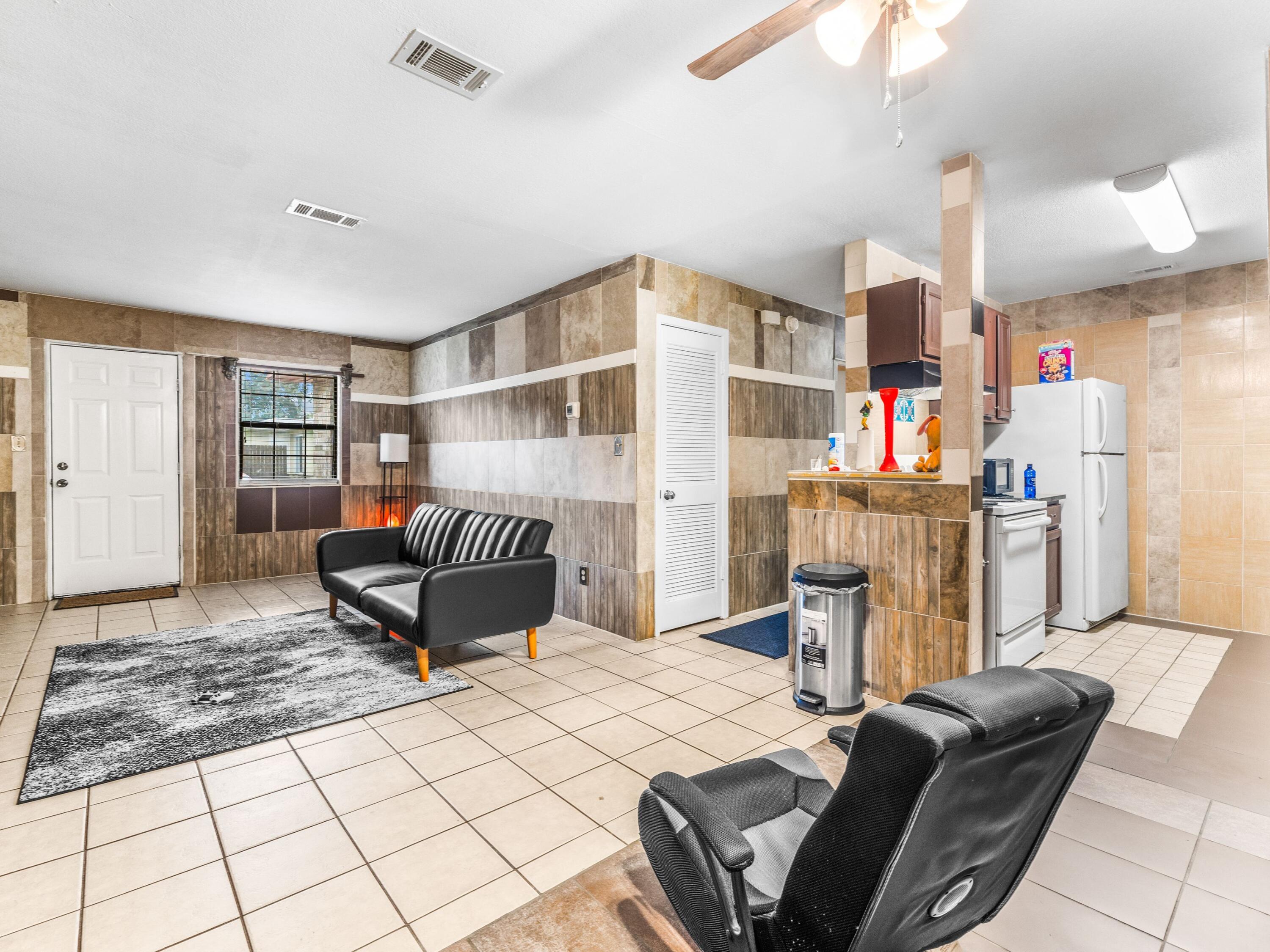 130 East 9 Mile Road, Unit 58 Pensacola, FL 32534 - Photo 35 of 50 a bedroom with furniture and a book shelf