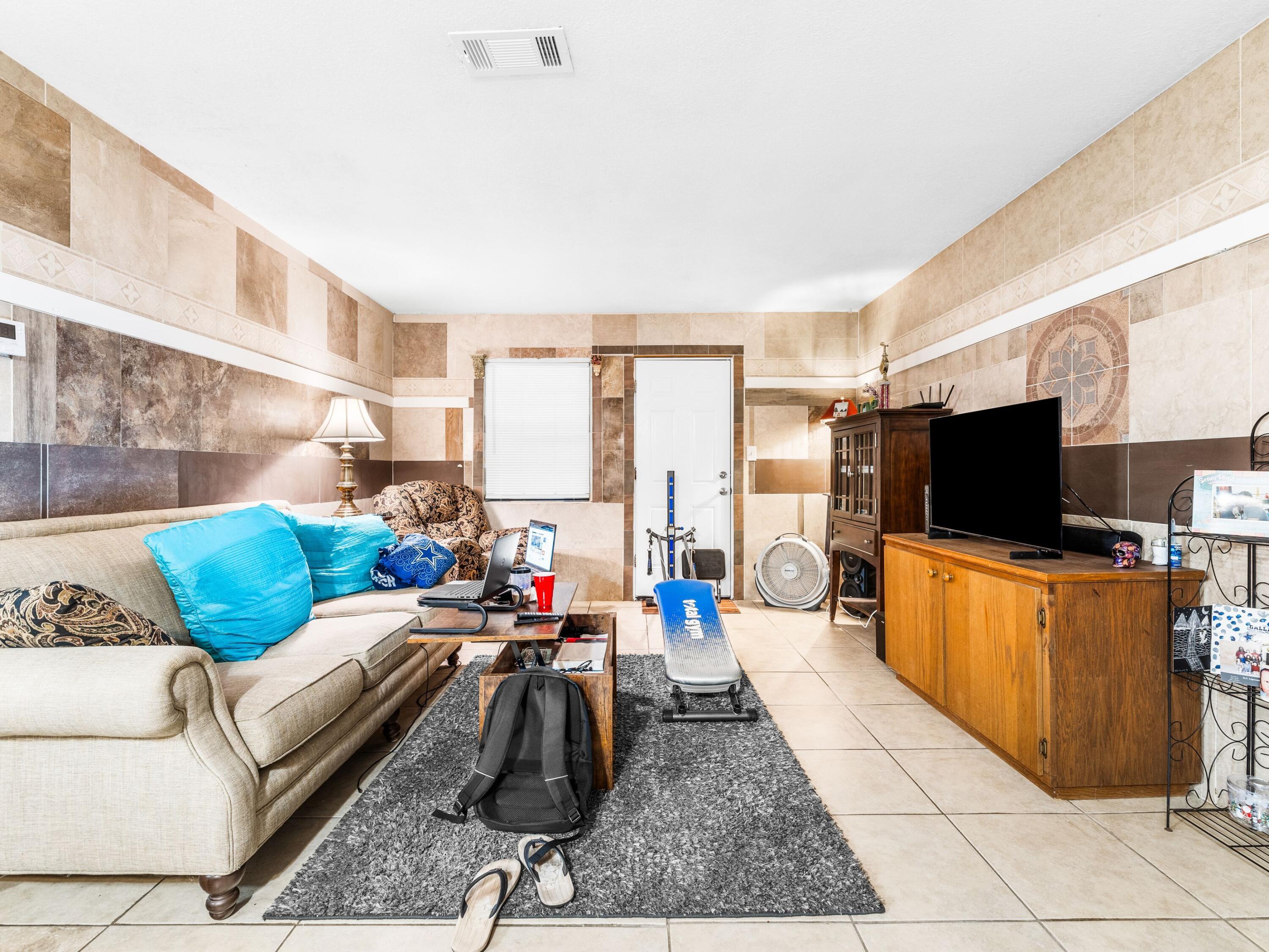 130 East 9 Mile Road, Unit 58 Pensacola, FL 32534 - Photo 37 of 50 a living room with furniture and a flat screen tv