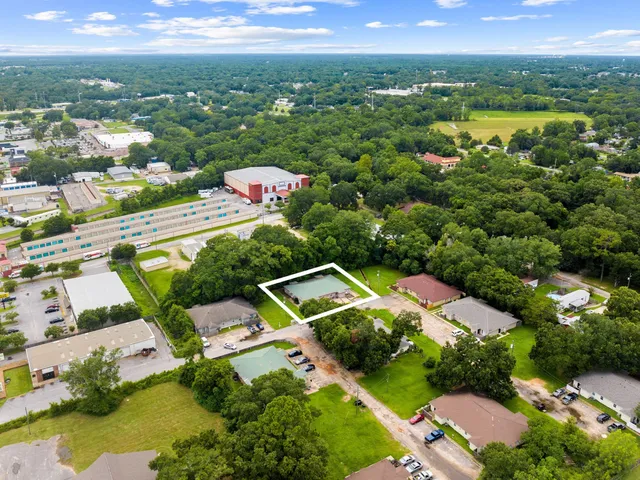 an aerial view of residential houses with outdoor space and river