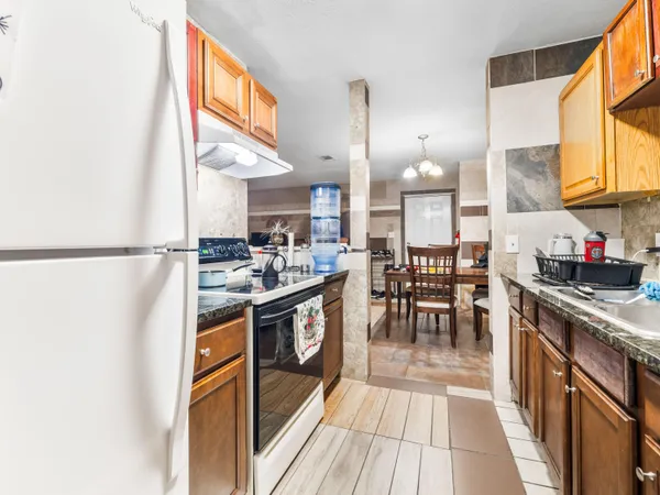 a kitchen with stainless steel appliances granite countertop a stove and a sink