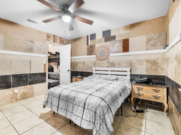 a bedroom with a bed and a view of kitchen