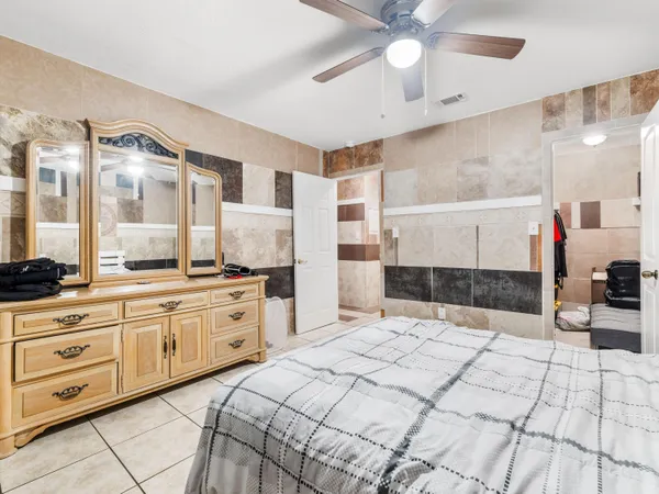 a spacious bathroom with a double vanity sink a mirror and a shower