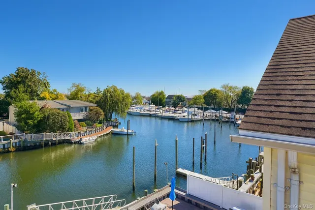 a view of a lake with couches and wooden floor
