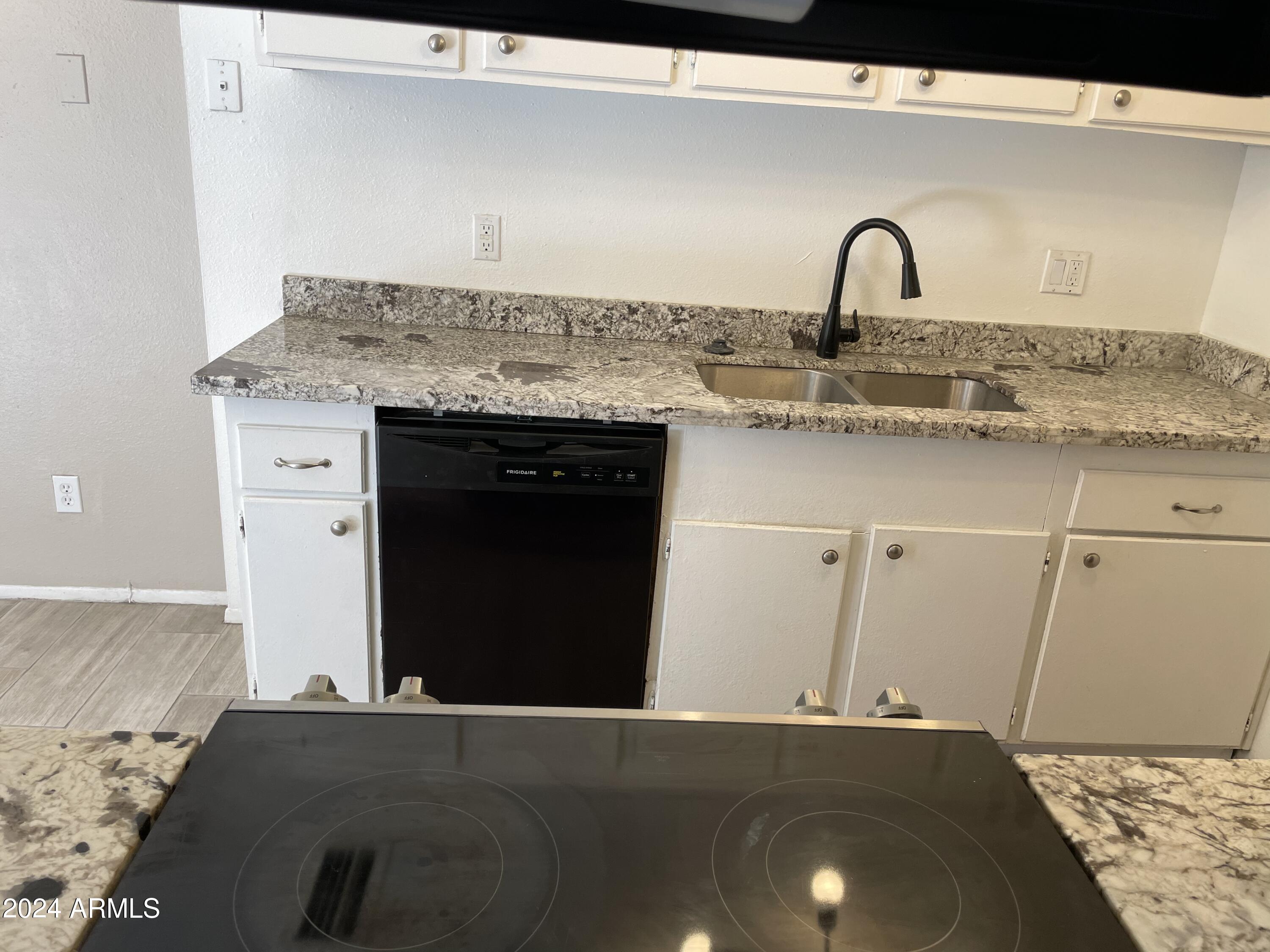 8233 North 34th Drive Phoenix, AZ 85051 - Photo 11 of 11 a kitchen with a sink and cabinets