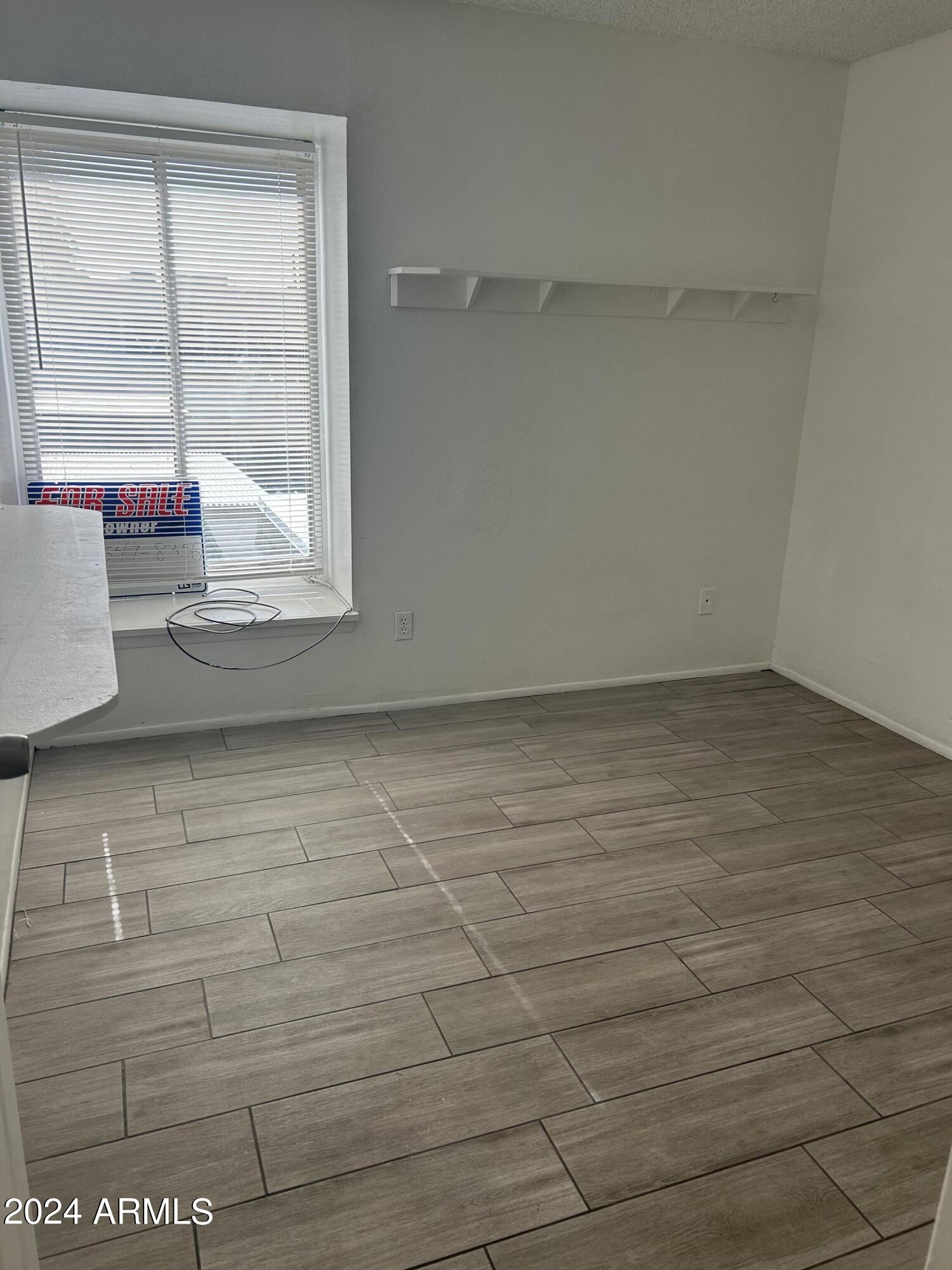 8233 North 34th Drive Phoenix, AZ 85051 - Photo 6 of 11 a view of a room with wooden floor and windows