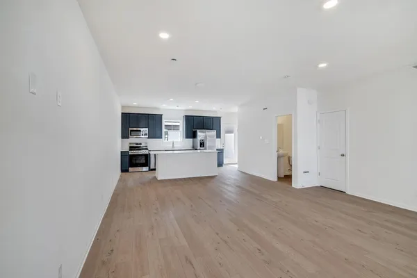 a view of a kitchen with cabinets and wooden floor
