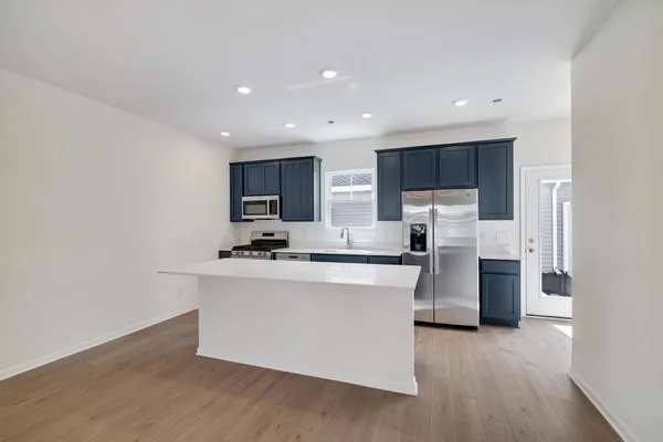a kitchen with stainless steel appliances a sink stove and refrigerator