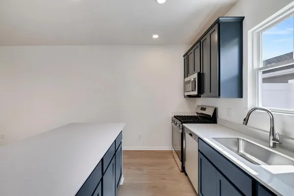 a kitchen with a sink and cabinets
