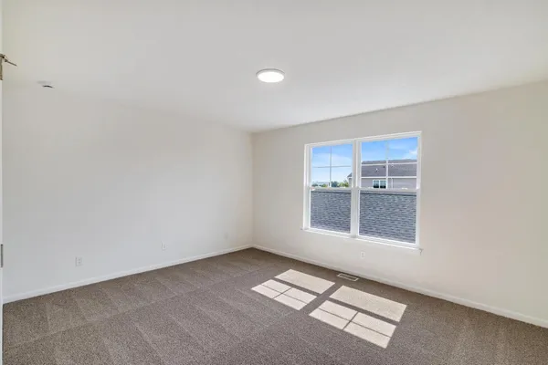 an empty room with a empty space and windows