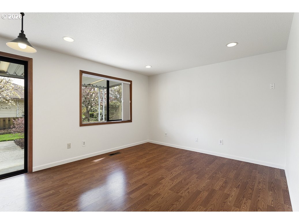 15638 Northeast Russell Place Portland, OR 97230 - Photo 13 of 46 an empty room with wooden floor and windows
