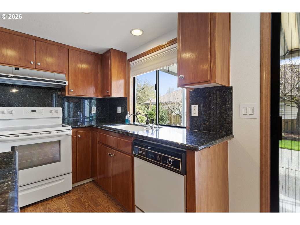 15638 Northeast Russell Place Portland, OR 97230 - Photo 14 of 46 a kitchen with stainless steel appliances granite countertop a stove a sink and a microwave
