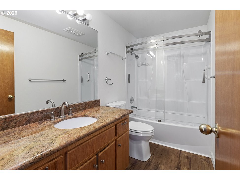 15638 Northeast Russell Place Portland, OR 97230 - Photo 27 of 46 a bathroom with a shower sink vanity mirror and toilet
