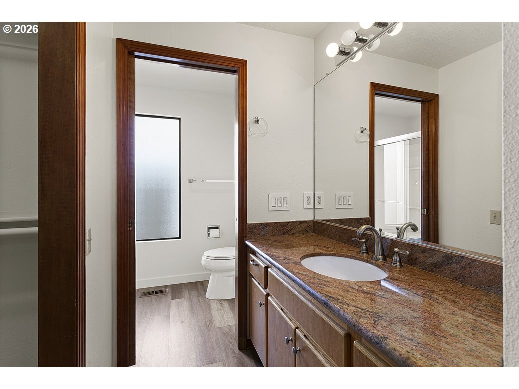 15638 Northeast Russell Place Portland, OR 97230 - Photo 28 of 46 a bathroom with a granite countertop sink and a mirror
