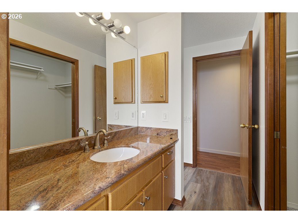 15638 Northeast Russell Place Portland, OR 97230 - Photo 31 of 46 a bathroom with a granite countertop sink a mirror and a shower