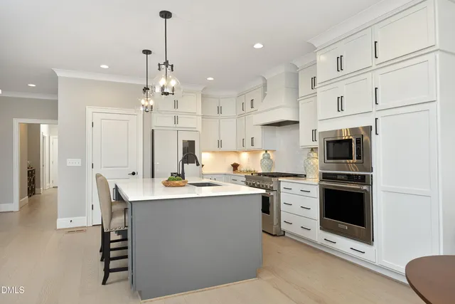 a spacious bathroom with a granite countertop sink a toilet a mirror and shower