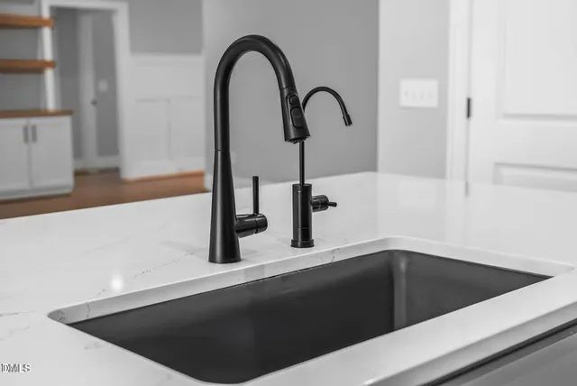 a utility room with sink dryer and washer