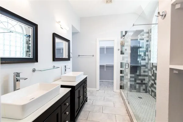a bathroom with a bathtub sink and mirror