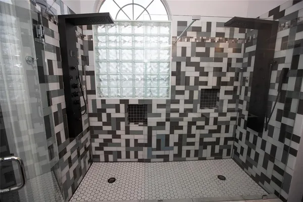 a bathroom with a bathtub and shower